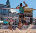 3 Männer spielen vor einem Publik am Forum Allgäu Beachvolleyball.